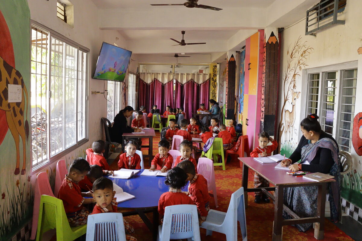 Nursery classroom from a different angle — kids working at tables