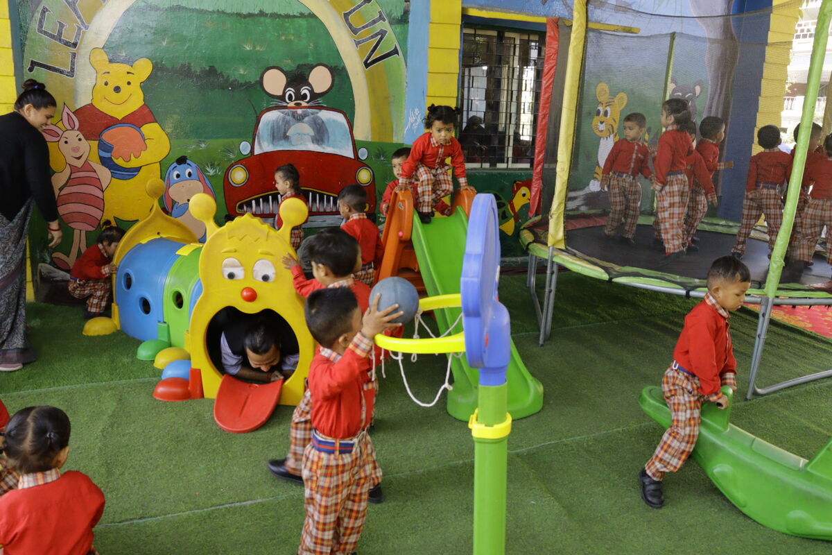 Nursery play area — slides, tunnels, and children at play