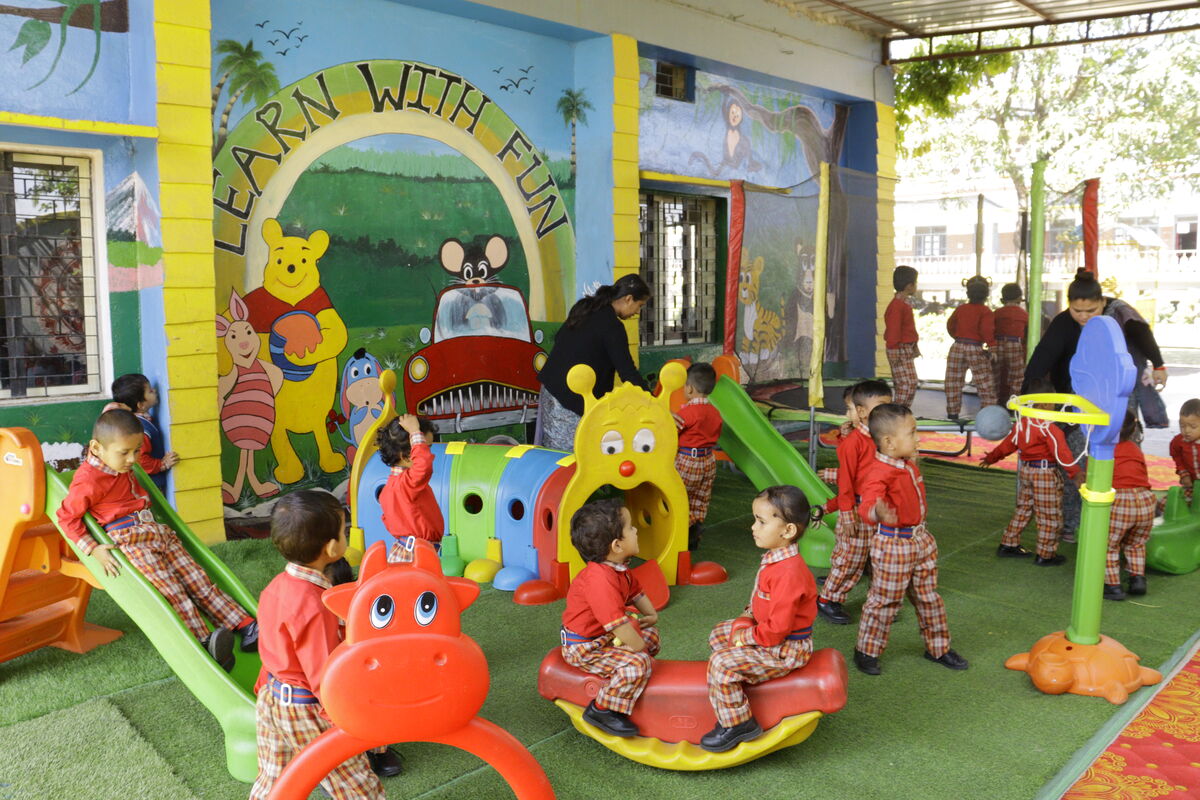 Children on slides and see-saws in the nursery play zone