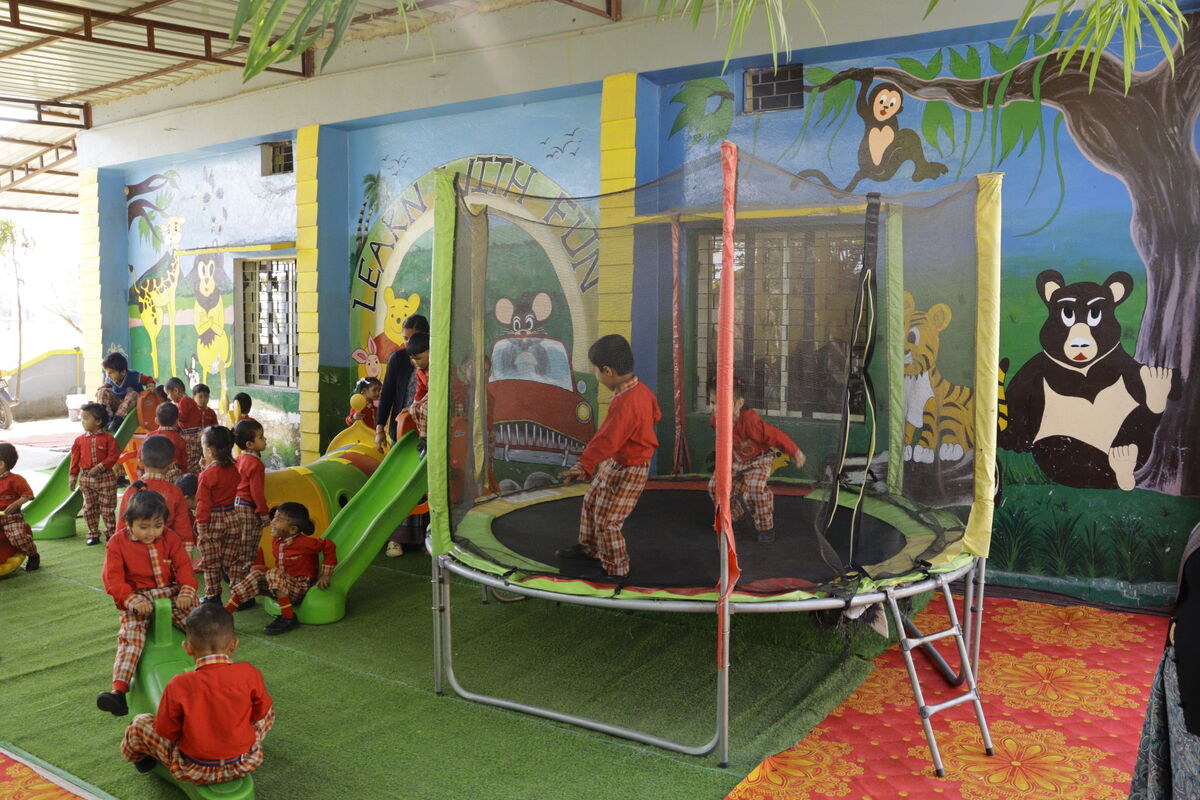 Full play zone — trampoline, slides, and colourful murals